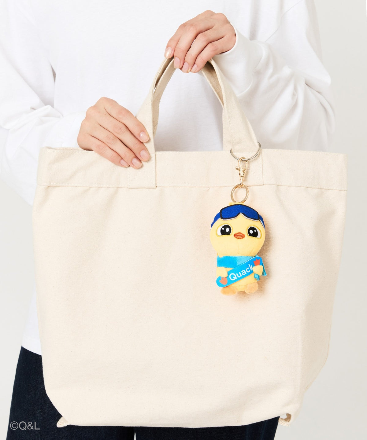 Snowboarding Mascot Quack on a tote bag, held